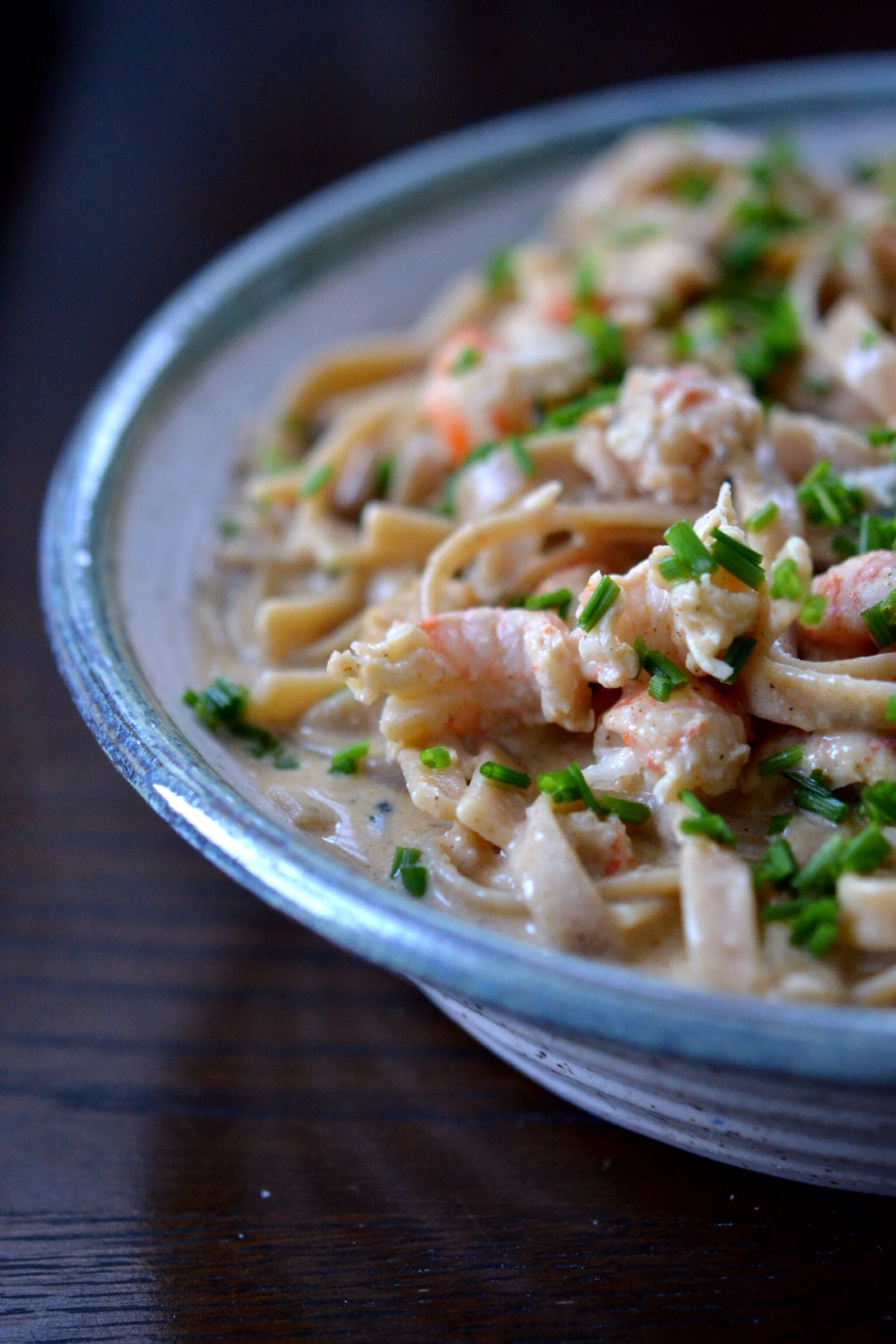 Langostino Cajun Fettuccine - Frozen langostino tails are simmered in a simple cream sauce along with garlic and Cajun seasoning before being piled on top of cooked fettuccine noodles. After being garnished with freshly chopped chives, this creamy, decadent, and slightly spicy pasta dish is ready to serve.