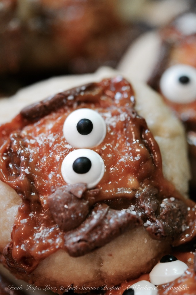 Milky Way Melted Ghost Cookies - These adorable Halloween cookies are so extremely festive, yet so easy to make. Simply place a mini Milky Way candy bar on top of each cookie before baking and then decorate with candy eyes and a light sprinkle of sea salt after taking out of the oven. How simple is that? These cookies are such a fun, festive, and adorably spooky holiday treat.