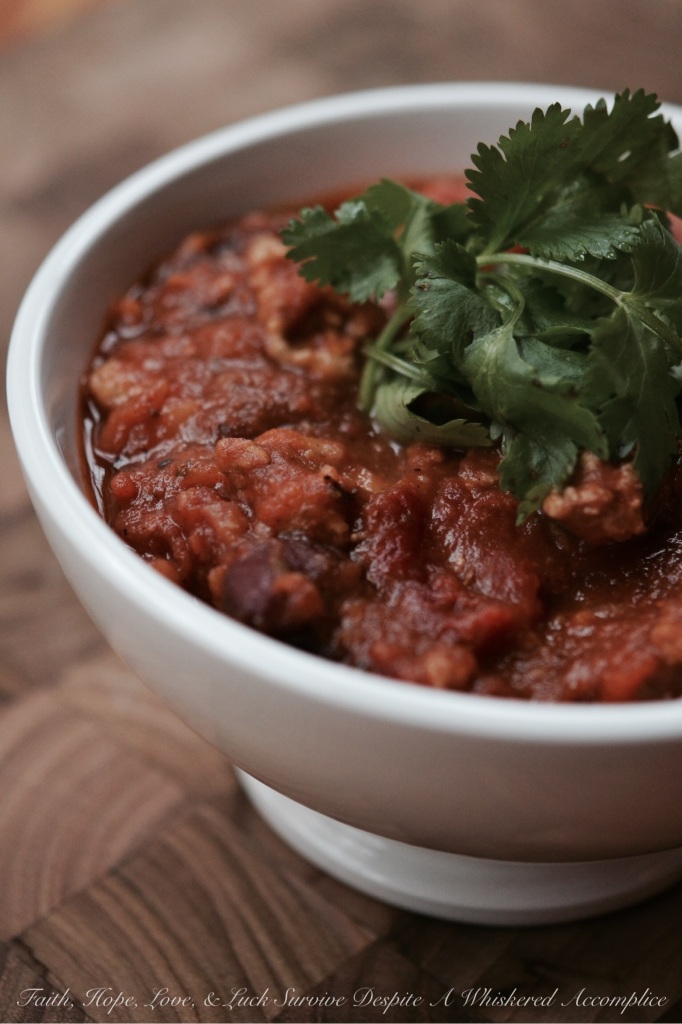 Crock Pot Pumpkin Chicken Chili - This autumn-inspired pumpkin chicken chili is hearty, full of flavor, and can be made ahead of time so you can enjoy it all week long or freeze some for later use. Ground chicken is browned with onions and garlic and then canned pumpkin, fire-roasted tomatoes, and beans are added along with traditional chili spices. Once the chili comes to a boil, transfer it to a crock pot and allow it to slowly cook for 8 hours on low heat. This allows the flavors to marry and deepen, creating a delicious large batch of chili that will have your family and friends asking for seconds.