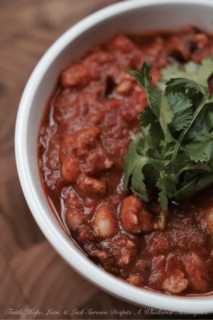 Crock Pot Pumpkin Chicken Chili - This autumn-inspired pumpkin chicken chili is hearty, full of flavor, and can be made ahead of time so you can enjoy it all week long or freeze some for later use. Ground chicken is browned with onions and garlic and then canned pumpkin, fire-roasted tomatoes, and beans are added along with traditional chili spices. Once the chili comes to a boil, transfer it to a crock pot and allow it to slowly cook for 8 hours on low heat. This allows the flavors to marry and deepen, creating a delicious large batch of chili that will have your family and friends asking for seconds.