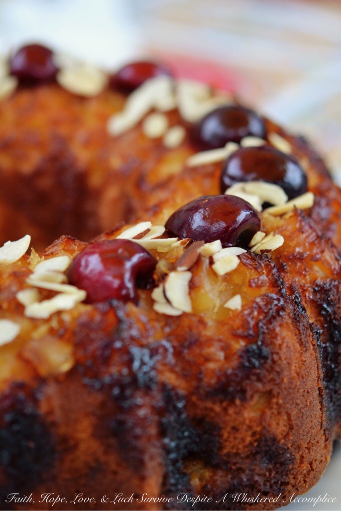 Pineapple Sundae Bundt Cake - This delicious buttery Bundt cake is not your average cake. It's loaded with pineapple and sliced almonds, and the fresh cherries and additional sliced almonds on top make a gorgeous and tasty garnish with lots of texture. Eating a slice of this cake is almost like having an ice cream sundae, minus the ice cream, of course.