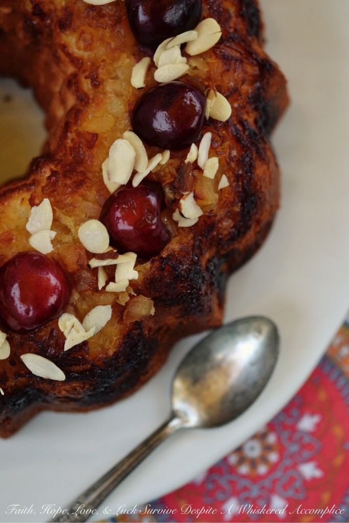 Pineapple Sundae Bundt Cake - This delicious buttery Bundt cake is not your average cake. It's loaded with pineapple and sliced almonds, and the fresh cherries and additional sliced almonds on top make a gorgeous and tasty garnish with lots of texture. Eating a slice of this cake is almost like having an ice cream sundae, minus the ice cream, of course.