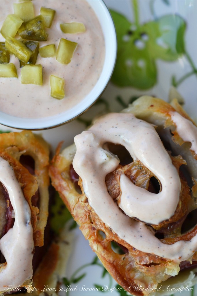 Corned Beef Pizza Swirls - St. Patrick's Day calls for a special appetizer, and these corned beef pizza swirls are that appetizer. They have just the right amount of corned beef lunchmeat and cheese rolled up inside of caraway seed-studded pizza dough. Add a swirl of homemade thousand island dressing on top and let the festive holiday celebration begin.