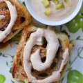 Corned Beef Pizza Swirls - St. Patrick's Day calls for a special appetizer, and these corned beef pizza swirls are that appetizer. They have just the right amount of corned beef lunchmeat and cheese rolled up inside of caraway seed-studded pizza dough. Add a swirl of homemade thousand island dressing on top and let the festive holiday celebration begin.