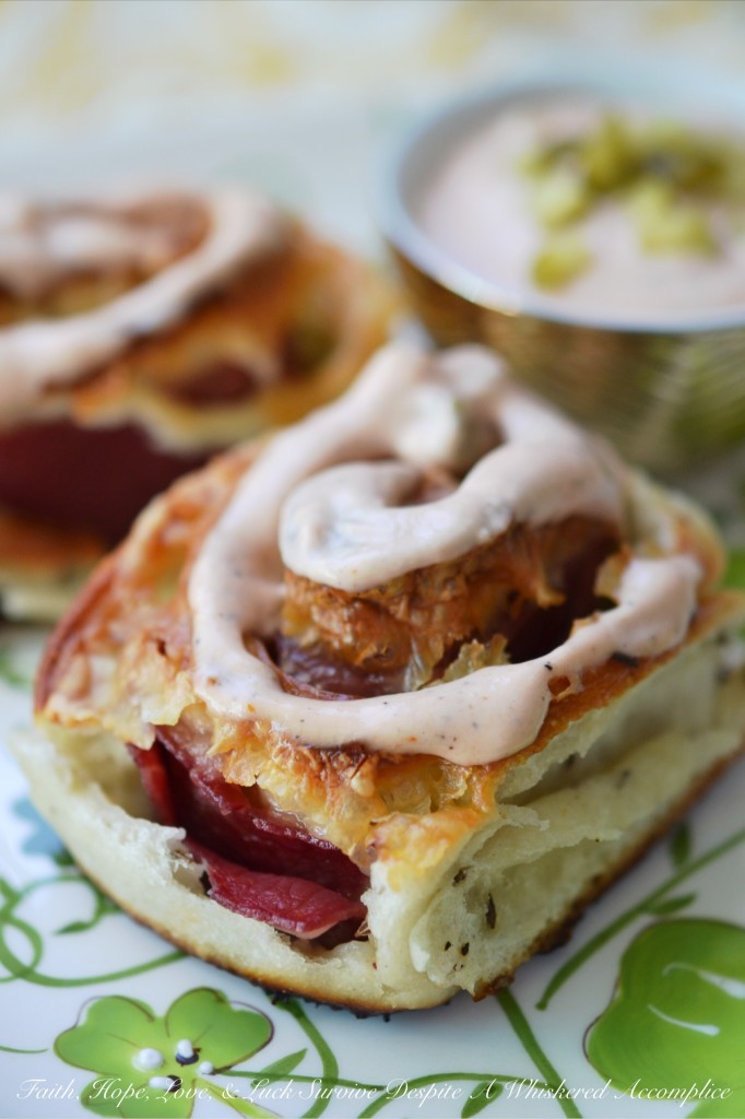 Corned Beef Pizza Swirls - St. Patrick's Day calls for a special appetizer, and these corned beef pizza swirls are that appetizer. They have just the right amount of corned beef lunchmeat and cheese rolled up inside of caraway seed-studded pizza dough. Add a swirl of homemade thousand island dressing on top and let the festive holiday celebration begin.