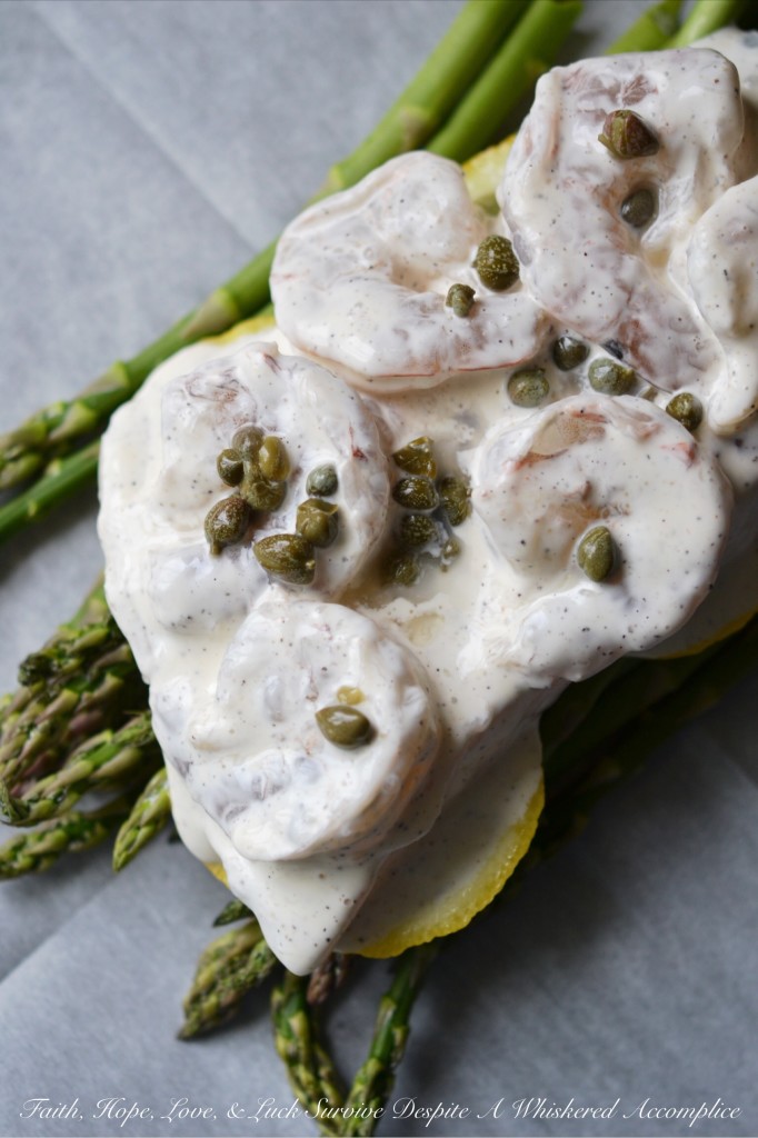 Lemony Mayonnaise Cod, Shrimp, and Asparagus Parchment Paper Wrapped Bundles - Get ready to enjoy a flavorful, flaky, and incredibly convenient meal that will become a new favorite in your dinnertime rotation. Flaky cod and succulent shrimp are baked to tender perfection along with crisp fresh asparagus and thin slices of zesty lemon in parchment paper-wrapped bundles. With their bright and creamy lemony mayonnaise sauce, these delightful fish and seafood bundles are perfect for a quick weeknight meal or a sophisticated weekend dinner.