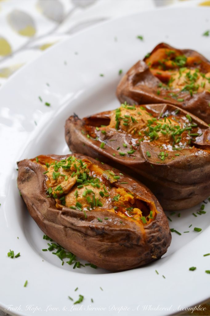 Crockpot Cajun Butter Roasted Sweet Potatoes - Looking for an easy summer BBQ side dish or a low-effort comforting winter Meatless Monday recipe? Look no further than these sweet crockpot roasted sweet potatoes topped with Cajun butter. These slow-cooked sweet potatoes could just easily become your new favorite way to eat sweet potatoes.