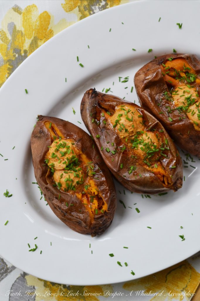 Crockpot Cajun Butter Roasted Sweet Potatoes - Looking for an easy summer BBQ side dish or a low-effort comforting winter Meatless Monday recipe? Look no further than these sweet crockpot roasted sweet potatoes topped with Cajun butter. These slow-cooked sweet potatoes could just easily become your new favorite way to eat sweet potatoes.