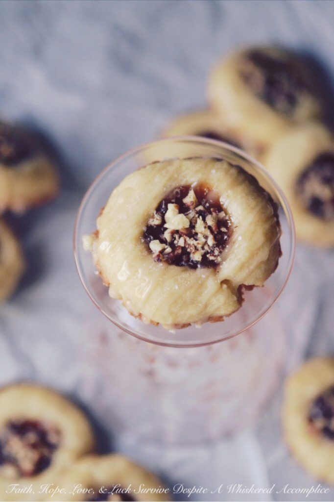 Strawberry Pecan Tea Cookies - These crumbly buttery thumbprint cookies go just as great with your morning coffee as they do with your afternoon tea. They're also just as tasty for dessert or a late-night snack. Filled with strawberry preserves, sprinkled with finely chopped pecans, and then drizzled with a sweet vanilla icing, these are one sweet crunchy tea cookie that you'll instantly swoon over.