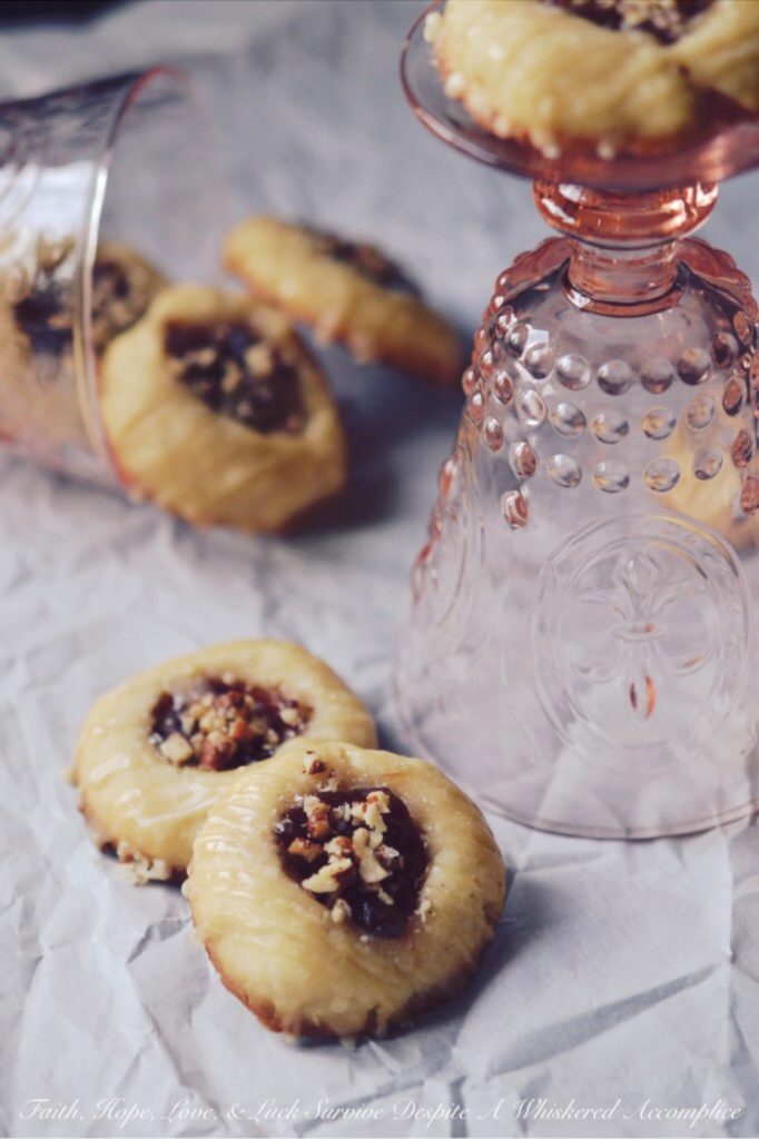 Strawberry Pecan Tea Cookies - These crumbly buttery thumbprint cookies go just as great with your morning coffee as they do with your afternoon tea. They're also just as tasty for dessert or a late-night snack. Filled with strawberry preserves, sprinkled with finely chopped pecans, and then drizzled with a sweet vanilla icing, these are one sweet crunchy tea cookie that you'll instantly swoon over.