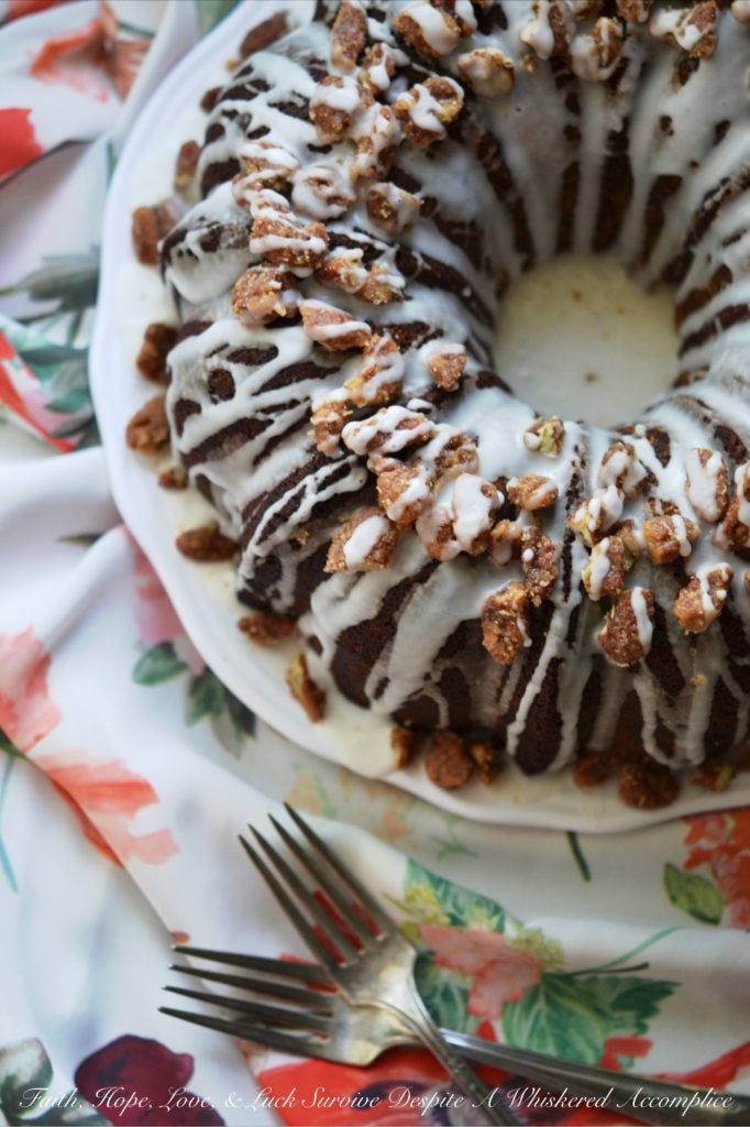 Jewish Praline Pecan Apple Cake - This apple-studded cake is the perfect Autumn Bundt. Topped with crunchy cinnamon praline pecans and drizzled with powdered sugar glaze, it's cake at its very best.
