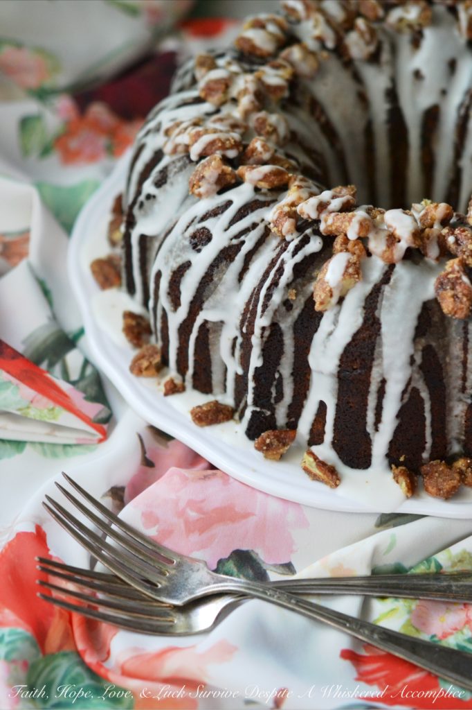 Jewish Praline Pecan Apple Cake - This apple-studded cake is the perfect Autumn Bundt. Topped with crunchy cinnamon praline pecans and drizzled with powdered sugar glaze, it's cake at its very best.