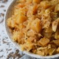 Autumn Crockpot Apple Sauerkraut - Give your crockpot sauerkraut the taste of autumn with the addition of seasonal apples, brown sugar, Oktoberfest beer, diced onion, and caraway seeds.