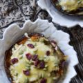 Chicken Enchilada Stuffed Acorn Squash - This warm autumn acorn squash dish is the perfect recipe to pull out to impress the guests at your next dinner party. Serve each guest half of an acorn squash filled with shredded chicken, green chile enchilada sauce, dried cranberries, and pepitas, topped with just the right amount of shredded cheddar cheese. Your guests will be begging you for the recipe afterward.