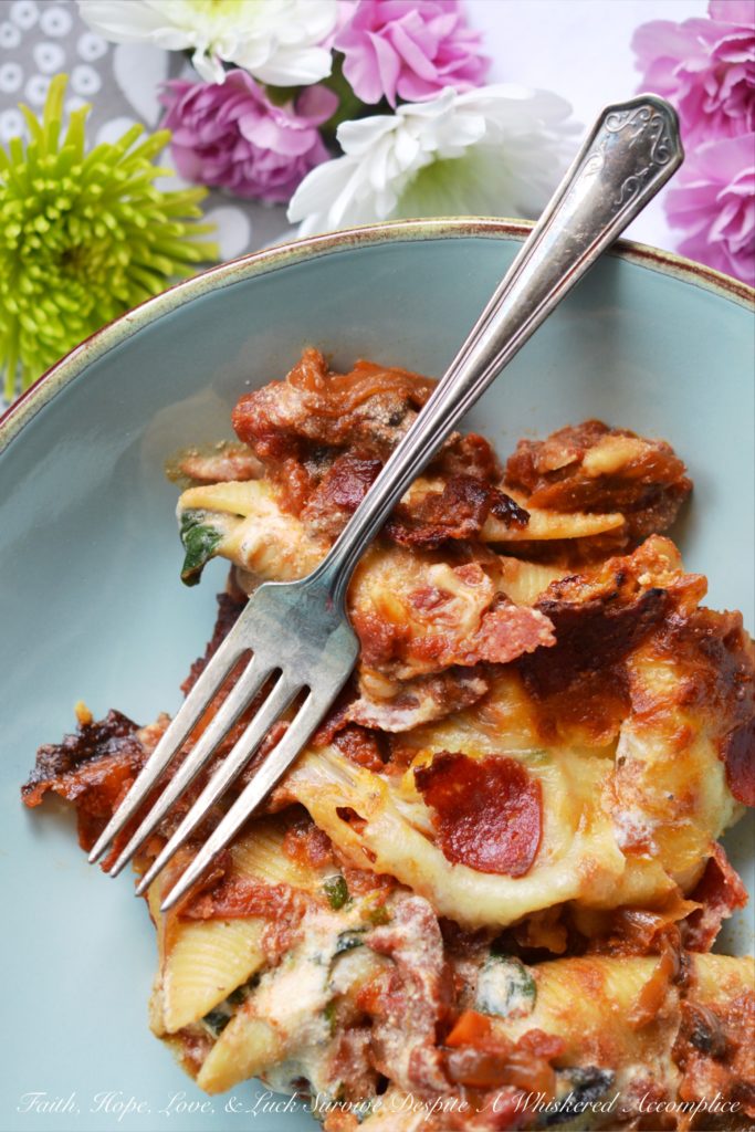 Spinach and Four-Cheese Stuffed Shells - This spinach and four-cheese stuffed shells Italian pasta dish is the perfect recipe to serve for a large family dinner, especially if you're trying to get your family to eat more spinach. After all, it's pretty hard to resist a baked pasta dish, topped with perfectly browned ooey-gooey cheese and crisp pepperoni.