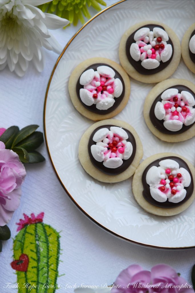 Chocolate Covered Russian Rose Shortbread - These gorgeous shortbread cookies are covered with melted dark chocolate and then decorated with beautiful handmade royal icing flowers, made using a Russian piping tip. For an easier-to-make version, you can forgo the royal icing flowers and decorate these miniature shortbread cookies with sprinkles, candy hearts, or any festive holiday candies.