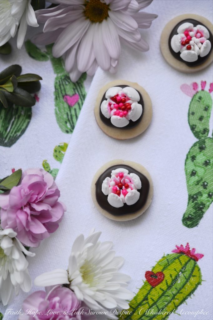 Chocolate Covered Russian Rose Shortbread - These gorgeous shortbread cookies are covered with melted dark chocolate and then decorated with beautiful handmade royal icing flowers, made using a Russian piping tip. For an easier-to-make version, you can forgo the royal icing flowers and decorate these miniature shortbread cookies with sprinkles, candy hearts, or any festive holiday candies.