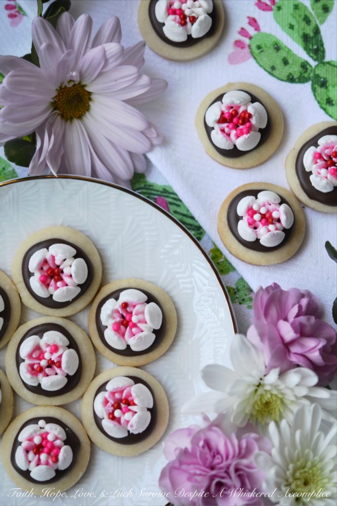 Chocolate Covered Russian Rose Shortbread - These gorgeous shortbread cookies are covered with melted dark chocolate and then decorated with beautiful handmade royal icing flowers, made using a Russian piping tip. For an easier-to-make version, you can forgo the royal icing flowers and decorate these miniature shortbread cookies with sprinkles, candy hearts, or any festive holiday candies.