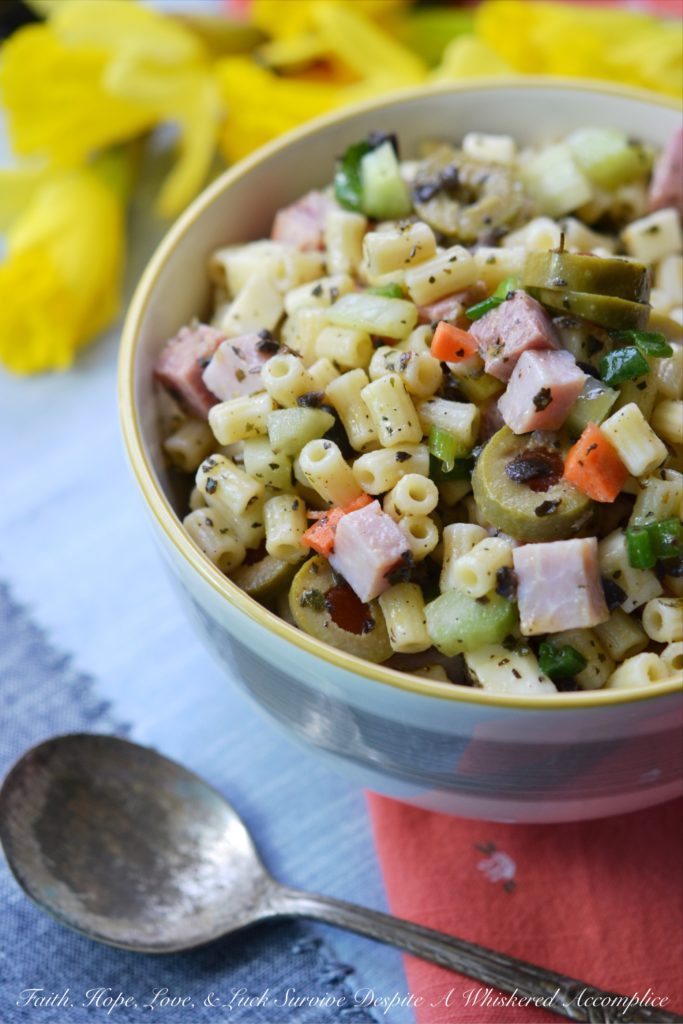 Muffuletta Pasta Salad - This amazingly flavorful muffuletta pasta salad has all of the good stuff in it, including ham, genoa salami, provolone cheese, celery, carrots, scallions, and lots and lots of green olives. It's definitely anything but bland, and I'm willing to bet that it may just become your new go-to pasta salad recipe.