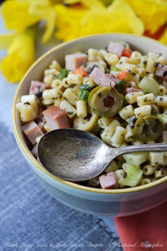 Muffuletta Pasta Salad - This amazingly flavorful muffuletta pasta salad has all of the good stuff in it, including ham, genoa salami, provolone cheese, celery, carrots, scallions, and lots and lots of green olives. It's definitely anything but bland, and I'm willing to bet that it may just become your new go-to pasta salad recipe.