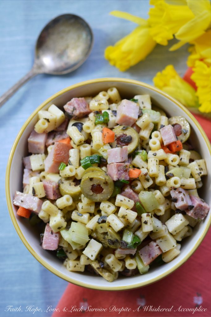 Muffuletta Pasta Salad - This amazingly flavorful muffuletta pasta salad has all of the good stuff in it, including ham, genoa salami, provolone cheese, celery, carrots, scallions, and lots and lots of green olives. It's definitely anything but bland, and I'm willing to bet that it may just become your new go-to pasta salad recipe.