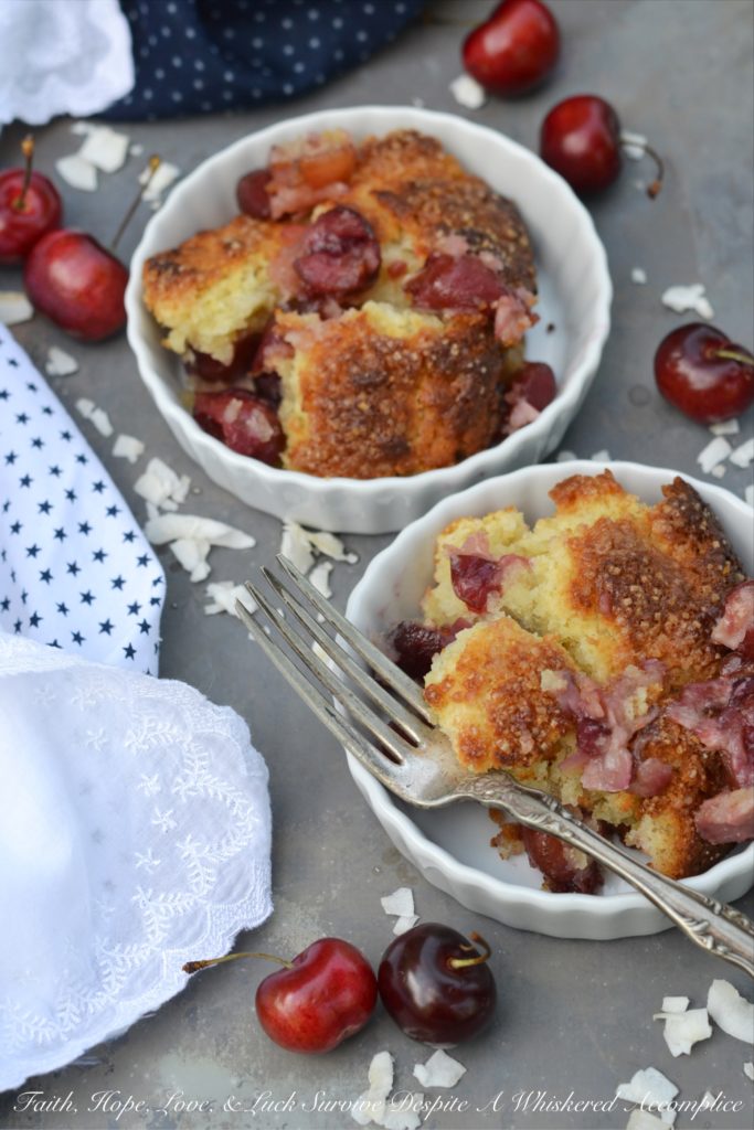 Drunken Sailor Coconut Cherry Cobbler - Who wouldn't love a drunken, fruit-enrobed, crunchy, sweet, cherry cobbler pillowy dough cloud? Coconut extract, unsweetened shredded coconut, and dark rum help to make this cherry cobbler one that any drunken sailor would willingly brave the seas for.