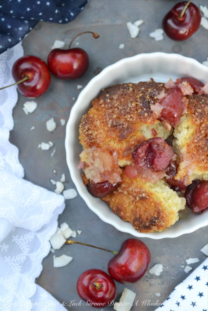 Drunken Sailor Coconut Cherry Cobbler - Who wouldn't love a drunken, fruit-enrobed, crunchy, sweet, cherry cobbler pillowy dough cloud? Coconut extract, unsweetened shredded coconut, and dark rum help to make this cherry cobbler one that any drunken sailor would willingly brave the seas for.