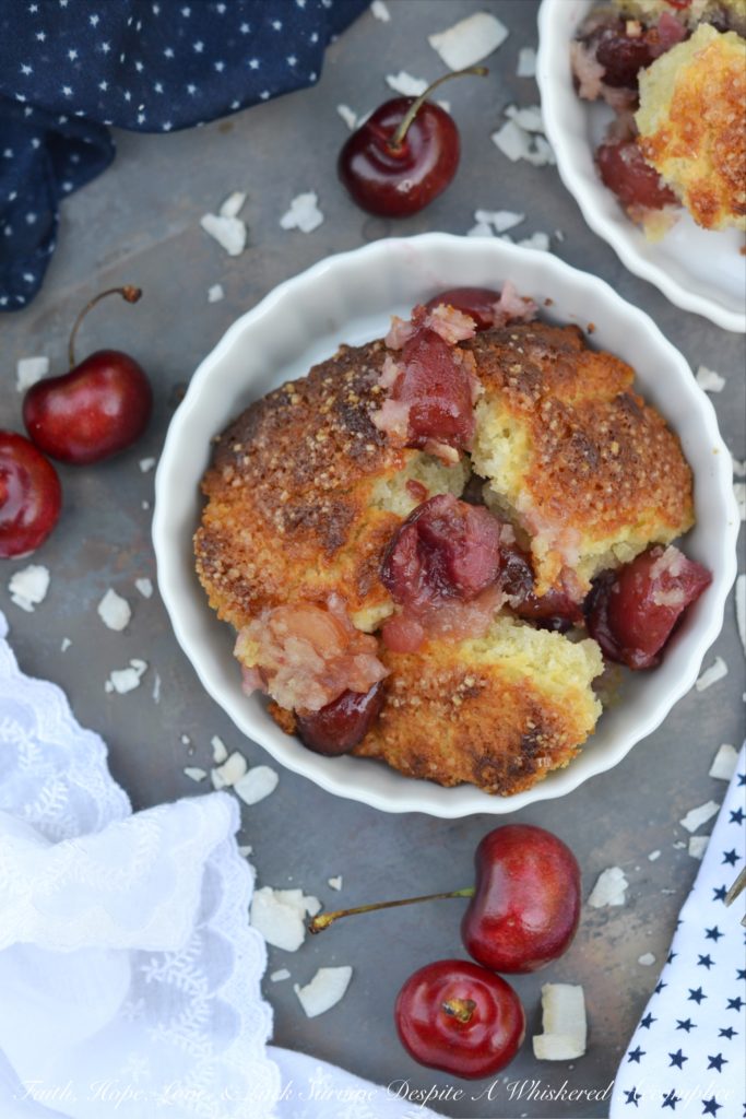 Drunken Sailor Coconut Cherry Cobbler - Who wouldn't love a drunken, fruit-enrobed, crunchy, sweet, cherry cobbler pillowy dough cloud? Coconut extract, unsweetened shredded coconut, and dark rum help to make this cherry cobbler one that any drunken sailor would willingly brave the seas for.