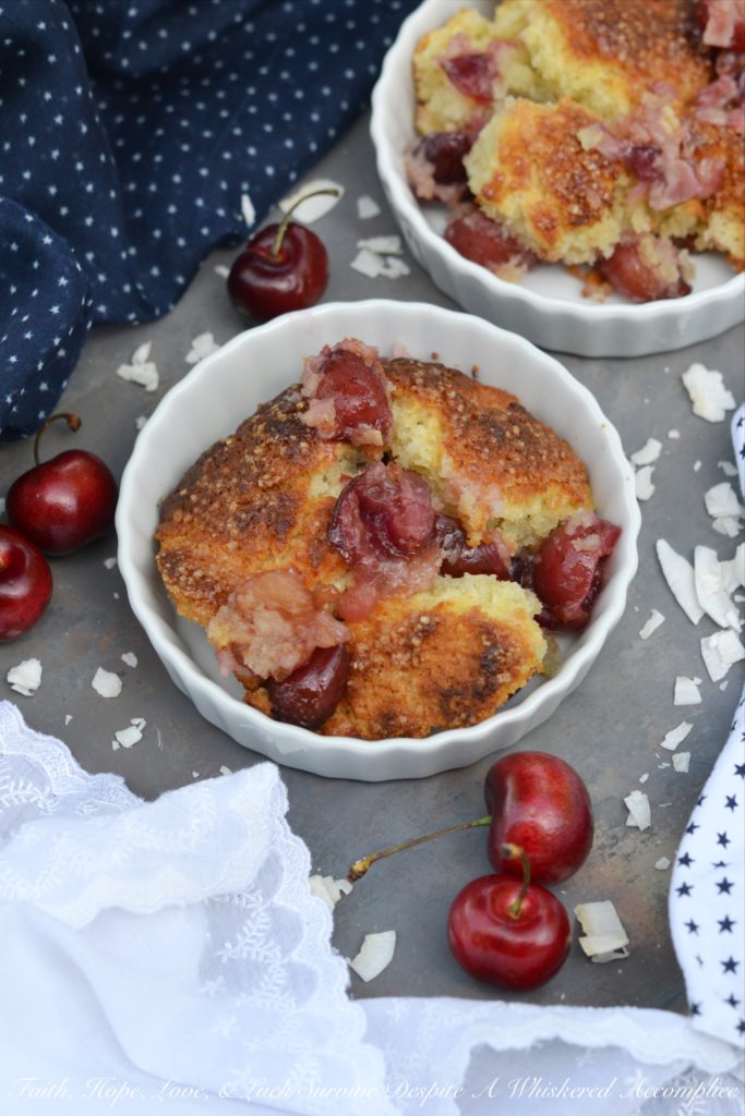 Drunken Sailor Coconut Cherry Cobbler - Who wouldn't love a drunken, fruit-enrobed, crunchy, sweet, cherry cobbler pillowy dough cloud? Coconut extract, unsweetened shredded coconut, and dark rum help to make this cherry cobbler one that any drunken sailor would willingly brave the seas for.