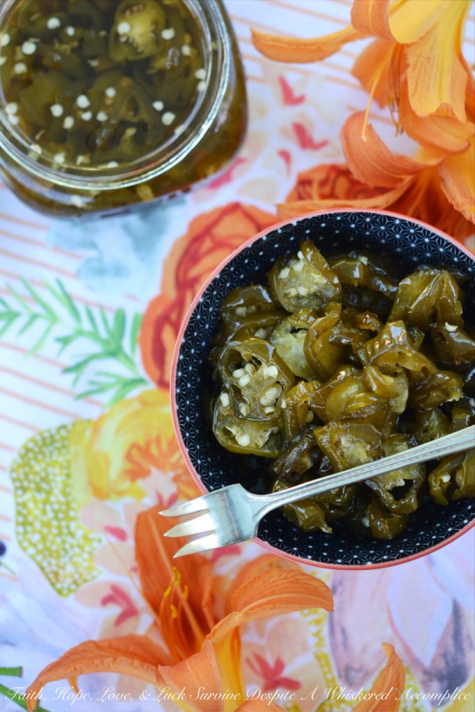 Candied Sliced Jalapeños - Add a little bit of sweet heat to all of your favorite summer sandwiches, salads, and appetizers with these sweet and spicy candied sliced jalapeños. These flavorful jalapeño slices take less than 20 minutes to cook and last up to 1 month in your refrigerator. I guarantee that you're going to want to use them on and in just about everything you make.
