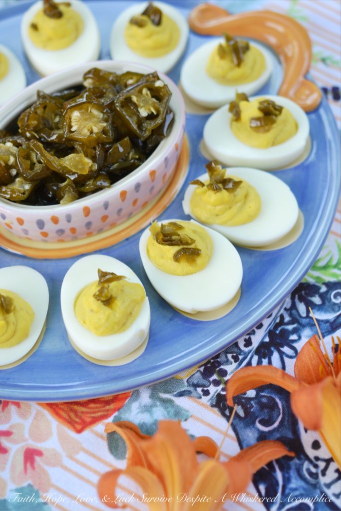 Sweet & Spicy Candied Jalapeño Deviled Eggs - These amazing deviled eggs are a little bit sweet and a little bit spicy, thanks to the addition of finely chopped candied sliced jalapeños. And, whether or not you make your own candied jalapeño slices or buy them from your local market, these eggs will definitely make a great addition to your next cookout, picnic, or family gathering.