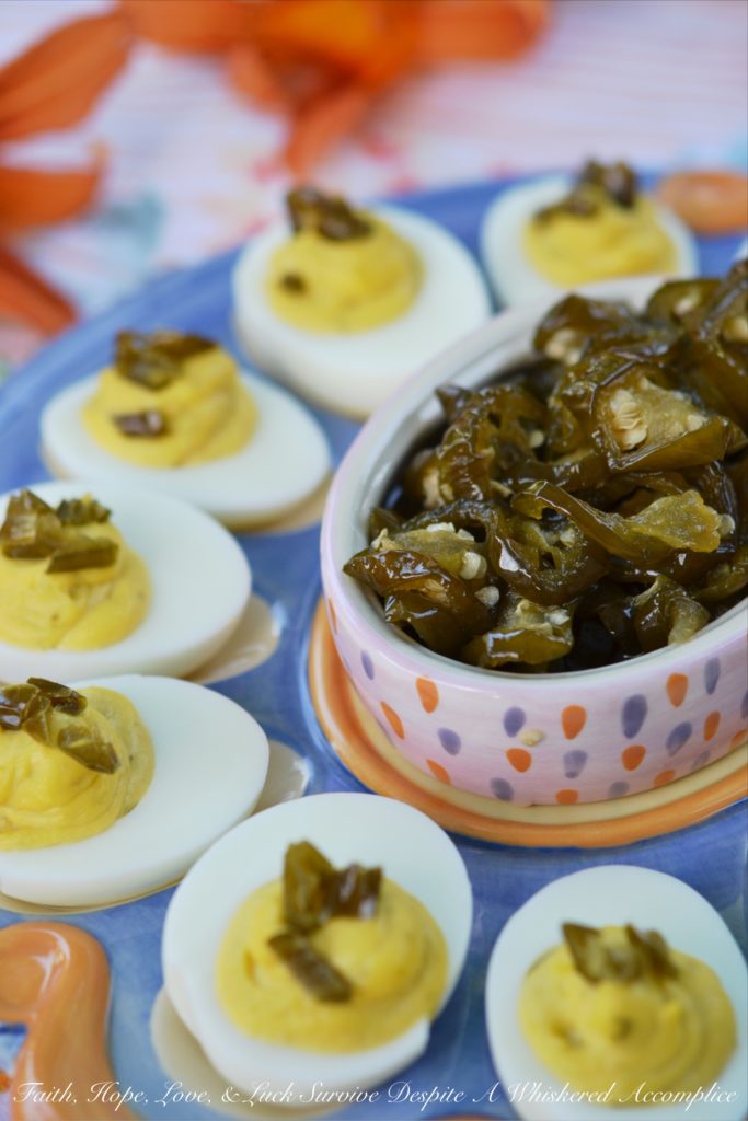 Sweet & Spicy Candied Jalapeño Deviled Eggs - These amazing deviled eggs are a little bit sweet and a little bit spicy, thanks to the addition of finely chopped candied sliced jalapeños. And, whether or not you make your own candied jalapeño slices or buy them from your local market, these eggs will definitely make a great addition to your next cookout, picnic, or family gathering.