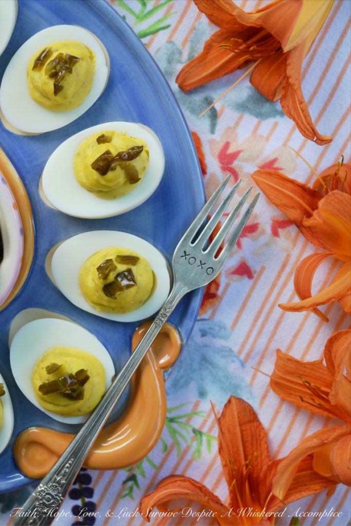 Sweet & Spicy Candied Jalapeño Deviled Eggs - These amazing deviled eggs are a little bit sweet and a little bit spicy, thanks to the addition of finely chopped candied sliced jalapeños. And, whether or not you make your own candied jalapeño slices or buy them from your local market, these eggs will definitely make a great addition to your next cookout, picnic, or family gathering.
