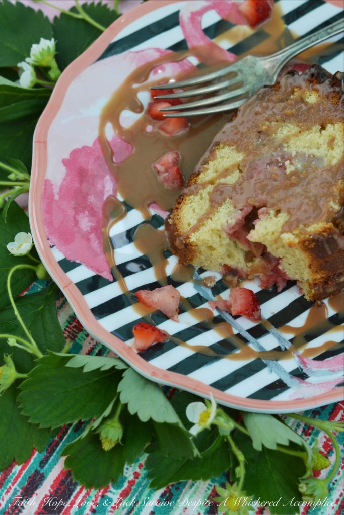 A delicate strawberry Bundt cake, poked and filled with strawberry purée, covered in chocolate sauce, and then garnished with even more fresh strawberries.