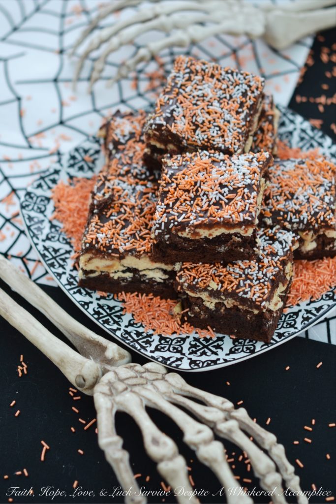 Fluffy Peanut Butter Nougat Chocolate Brownies - These moist and decadent brownies are topped with fluffy peanut butter nougat and peanuts, before being spread with a thick heavenly chocolate icing.