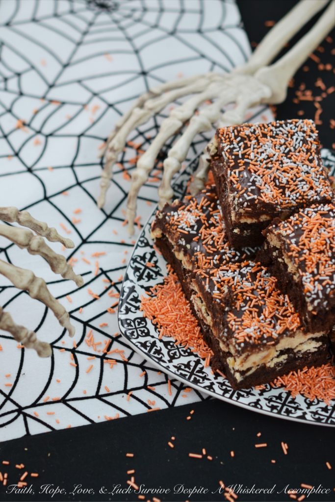Fluffy Peanut Butter Nougat Chocolate Brownies - These moist and decadent brownies are topped with fluffy peanut butter nougat and peanuts, before being spread with a thick heavenly chocolate icing.