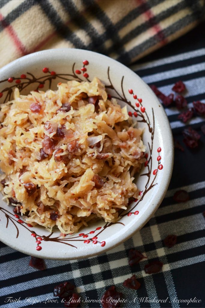 Sweet Cranberry Slow Cooker Sauerkraut - Imagine sauerkraut all dressed up in its holiday best, simmering away in a slow cooker with beer, maple syrup, brown sugar, and dried cranberries.
