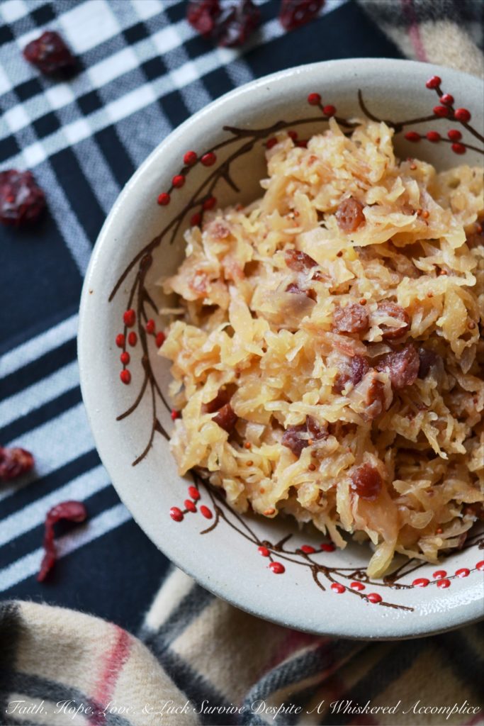 Sweet Cranberry Slow Cooker Sauerkraut - Imagine sauerkraut all dressed up in its holiday best, simmering away in a slow cooker with beer, maple syrup, brown sugar, and dried cranberries.