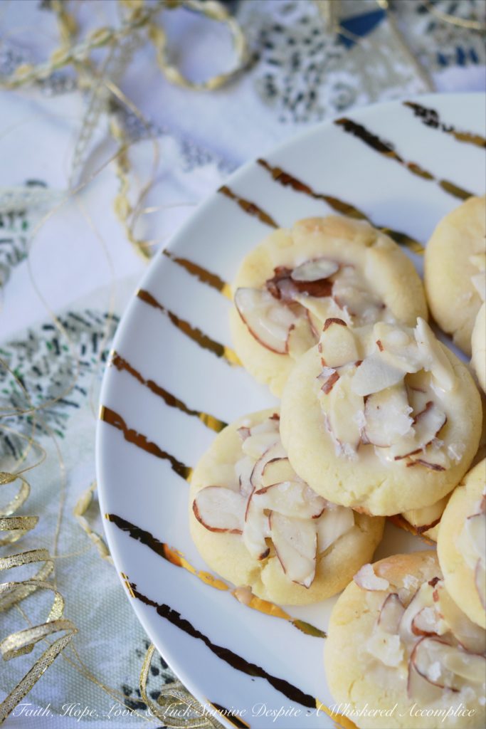 Heavenly Almond Cookies - These crumbly and buttery shortbread Christmas cookies are topped with sliced almonds and then drizzled with a heavenly eggnog-infused almond glaze.