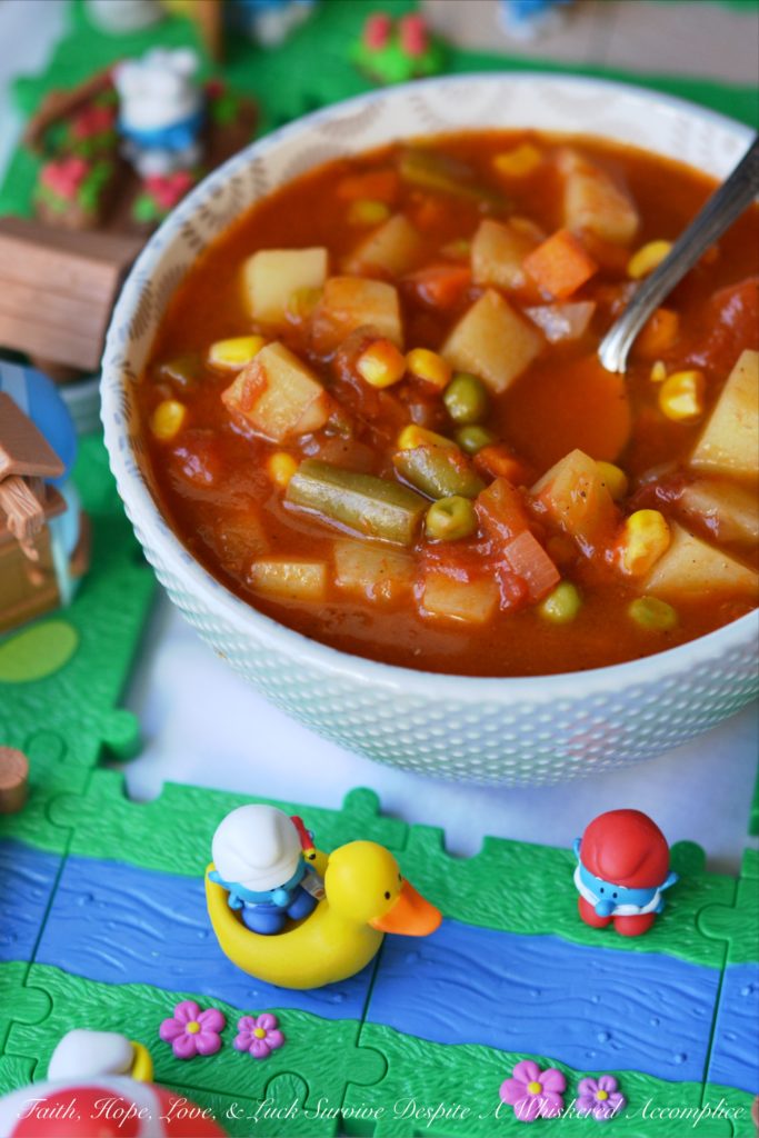 Classic Childhood Vegetable Soup - This classic childhood vegetable soup is loaded with potatoes, carrots, corn, green beans, peas, and onions. Its rich tomato base is prepared using tomato paste, low-sodium beef broth, and a can of crushed tomatoes. With the addition of a sweet yellow onion, a few red potatoes, and a bag of frozen mixed vegetables, this classic childhood favorite gets an extra boost of flavor and nutrition. Add in a couple of bay leaves, a sprinkle of salt and pepper, and you’ve got yourself a big ol’ pot of simple, soul-soothing homemade soup. It's comfort food at its best.