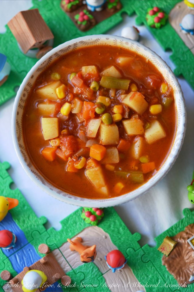 Classic Childhood Vegetable Soup - This classic childhood vegetable soup is loaded with potatoes, carrots, corn, green beans, peas, and onions. Its rich tomato base is prepared using tomato paste, low-sodium beef broth, and a can of crushed tomatoes. With the addition of a sweet yellow onion, a few red potatoes, and a bag of frozen mixed vegetables, this classic childhood favorite gets an extra boost of flavor and nutrition. Add in a couple of bay leaves, a sprinkle of salt and pepper, and you’ve got yourself a big ol’ pot of simple, soul-soothing homemade soup. It's comfort food at its best.