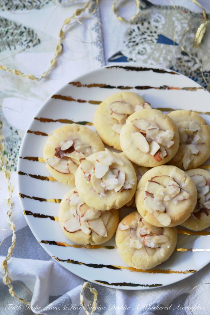 Heavenly Almond Cookies - These crumbly and buttery shortbread Christmas cookies are topped with sliced almonds and then drizzled with a heavenly eggnog-infused almond glaze.