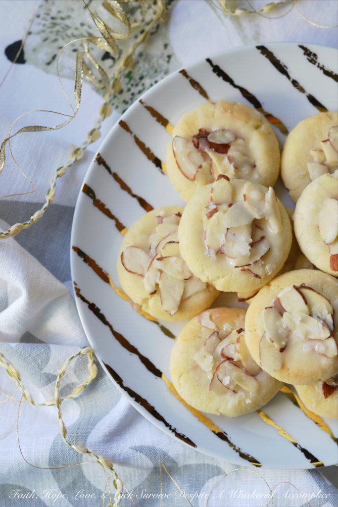 Heavenly Almond Cookies - These crumbly and buttery shortbread Christmas cookies are topped with sliced almonds and then drizzled with a heavenly eggnog-infused almond glaze.