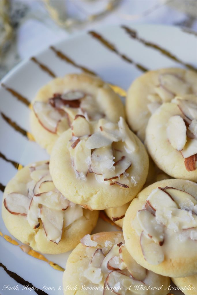 Heavenly Almond Cookies - These crumbly and buttery shortbread Christmas cookies are topped with sliced almonds and then drizzled with a heavenly eggnog-infused almond glaze.