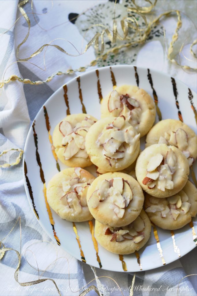 Heavenly Almond Cookies - These crumbly and buttery shortbread Christmas cookies are topped with sliced almonds and then drizzled with a heavenly eggnog-infused almond glaze.