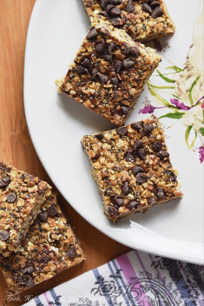 Peanut Butter & Chocolate Chip Granola Squares - These healthier homemade granola squares are incredibly easy to make at home with just a few simple ingredients. You’ll love the chewy texture from quick-cooking oats, the boost of nutrition from chia seeds, and the satisfying flavor of creamy peanut butter. A drizzle of honey provides a touch of sweetness, and a scattering of mini chocolate chips makes them irresistibly good.