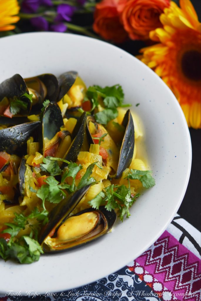 Coconut Curried Mussels - Mussels are a fantastic ingredient to cook with, as they can be easily transformed into either a delicious main dish or a flavorful seafood appetizer. In this mussel recipe, light coconut milk and curry seasoning blend together with diced sweet yellow onion and tomato, to make these fresh mussels both flavorful and unforgettable.