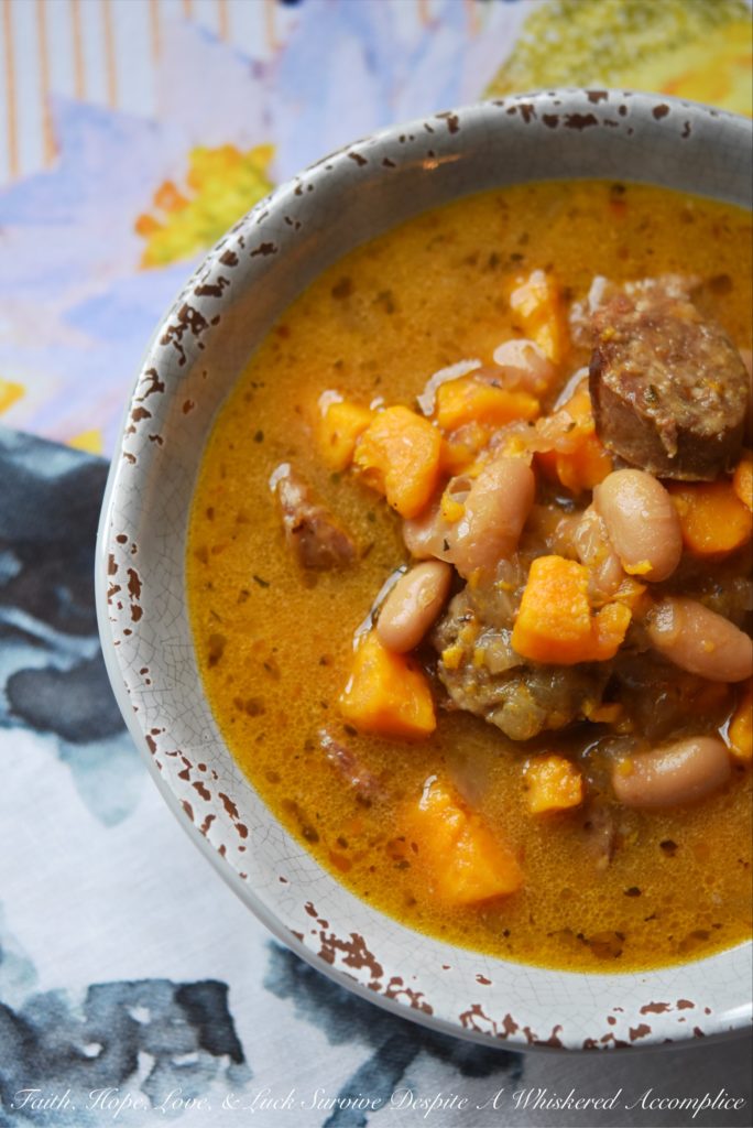 Cajun Bratwurst Slow-Cooker Soup - This bratwurst slow-cooker soup, containing cannellini beans and sweet potatoes, has just the right amount of Cajun kick with just a touch of sweetness. A can of light coconut milk also helps give this slow-cooked soup a hint of richness without making it too fattening.