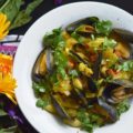 Coconut Curried Mussels - Mussels are a fantastic ingredient to cook with, as they can be easily transformed into either a delicious main dish or a flavorful seafood appetizer. In this mussel recipe, light coconut milk and curry seasoning blend together with diced sweet yellow onion and tomato, to make these fresh mussels both flavorful and unforgettable.