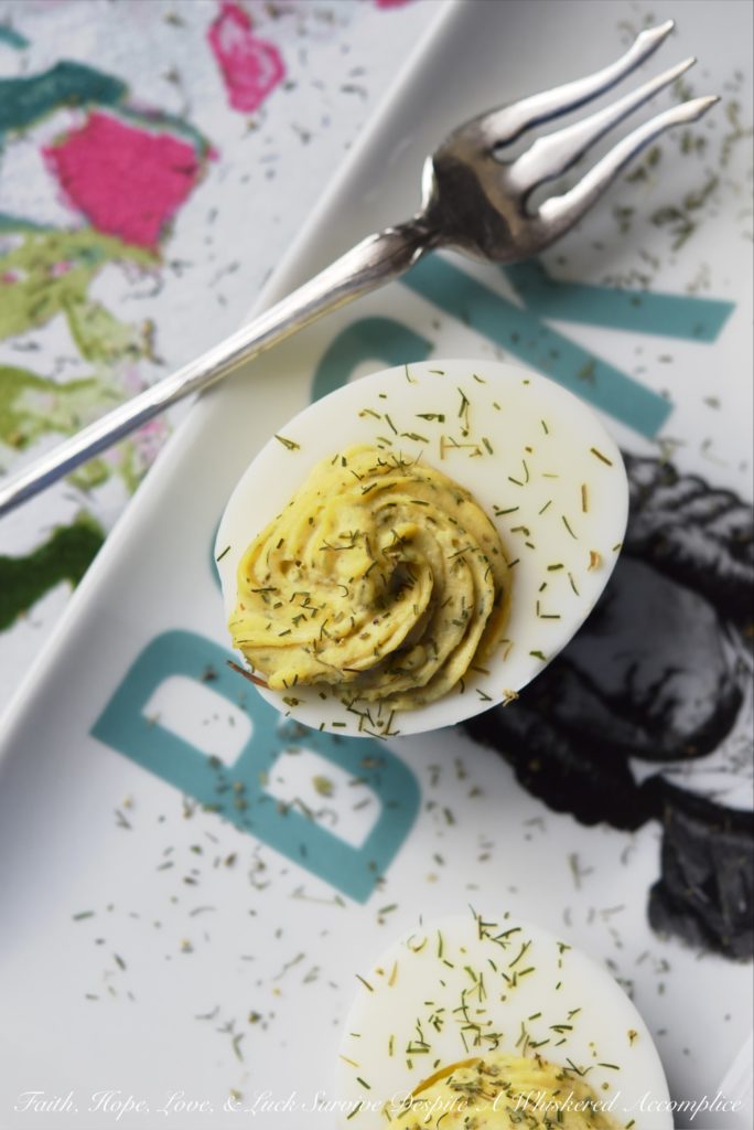 Dill Weed Deviled Eggs - Make ordinary deviled eggs "egg"traordinary with the addition of dill weed, pickle juice, mayonnaise, Dijon mustard, salt, pepper, and just a touch of sugar.